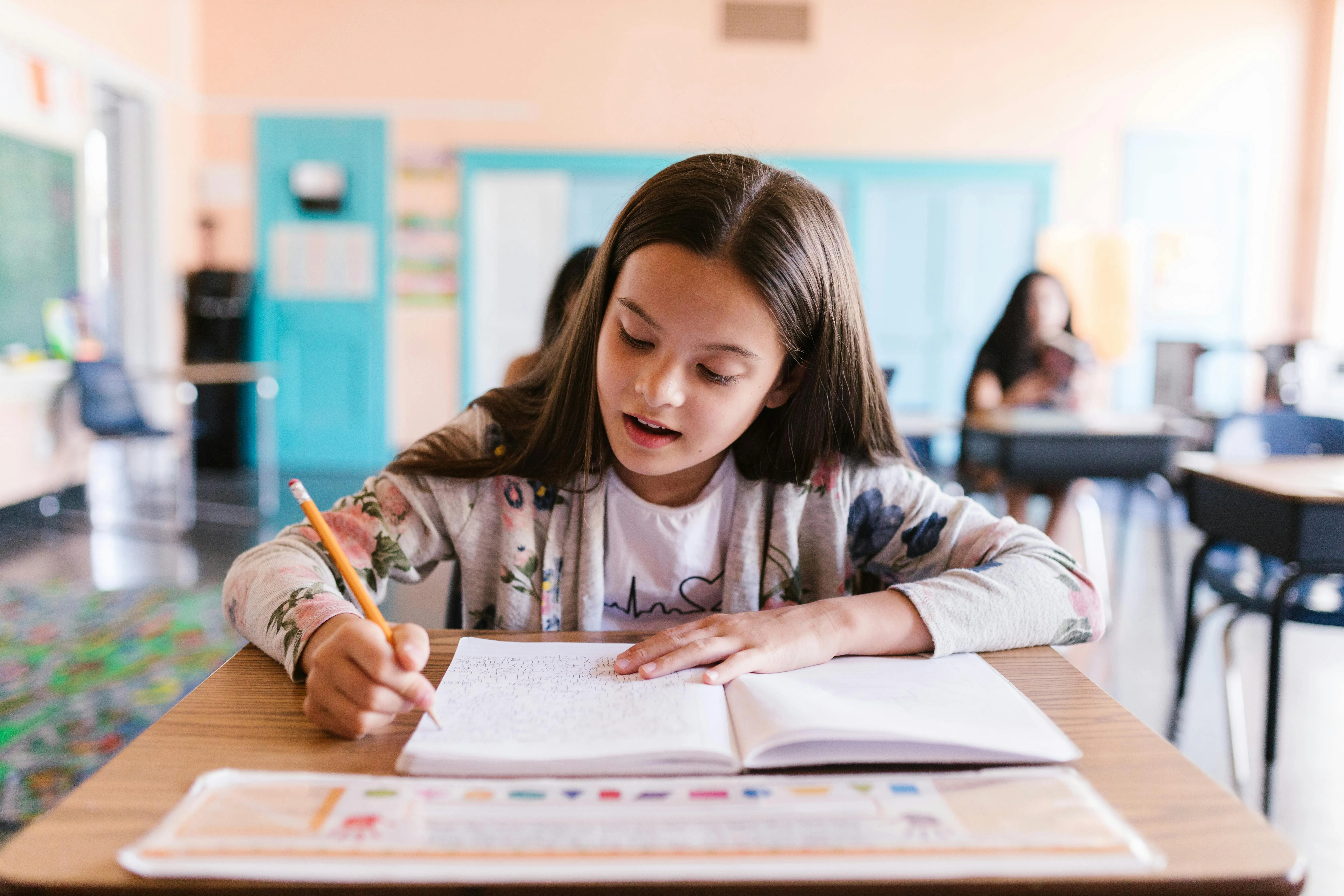 Young student engaged in learning with educational materials and focused study environment